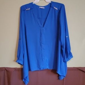 Long flowy blue blouse.